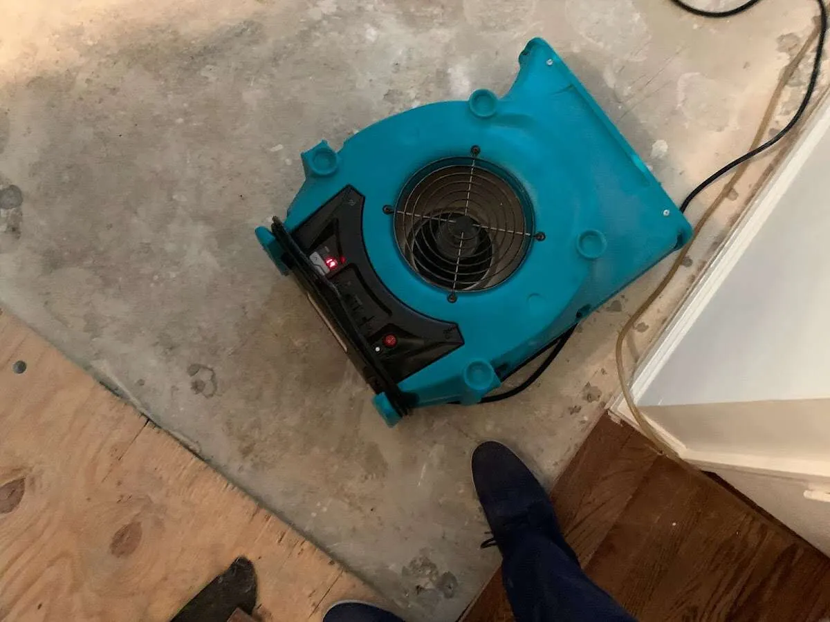 Air mover drying subfloor during Commercial Water Damage Restoration in Cuyahoga Falls